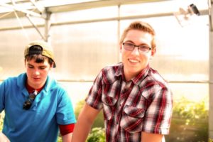 student in greenhouse